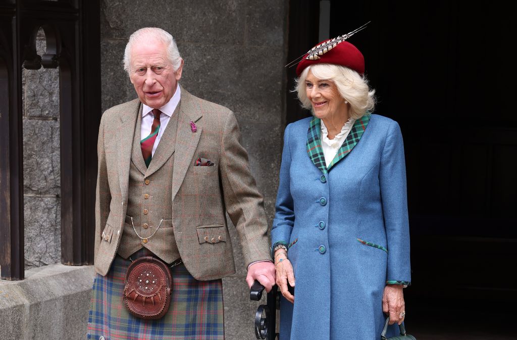 charles and camilla posing outside church