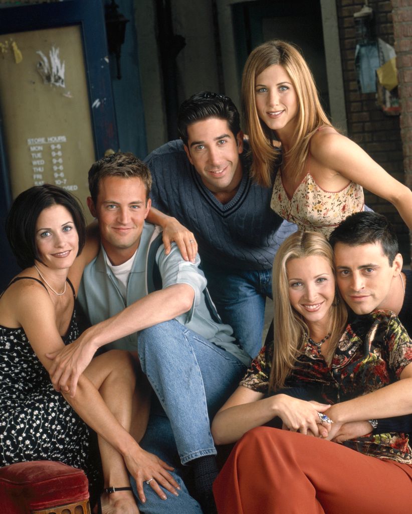 cast of friends posing on couch
