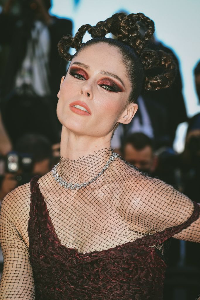 Coco Rocha with red smoky eyeshadow and elaborate braided hair 