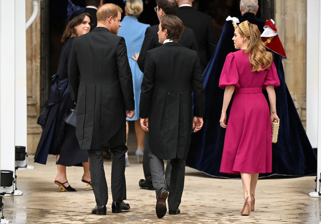 Princess Eugenie smiles back at Prince Harry as they enter the Abbey