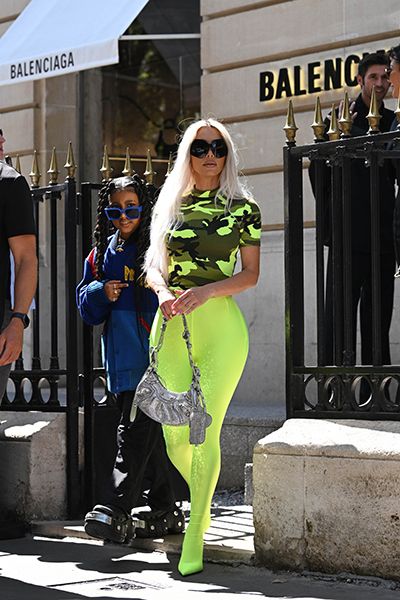 Kim Kardashian looks striking in a camo top and neon green leggings while  out shopping at