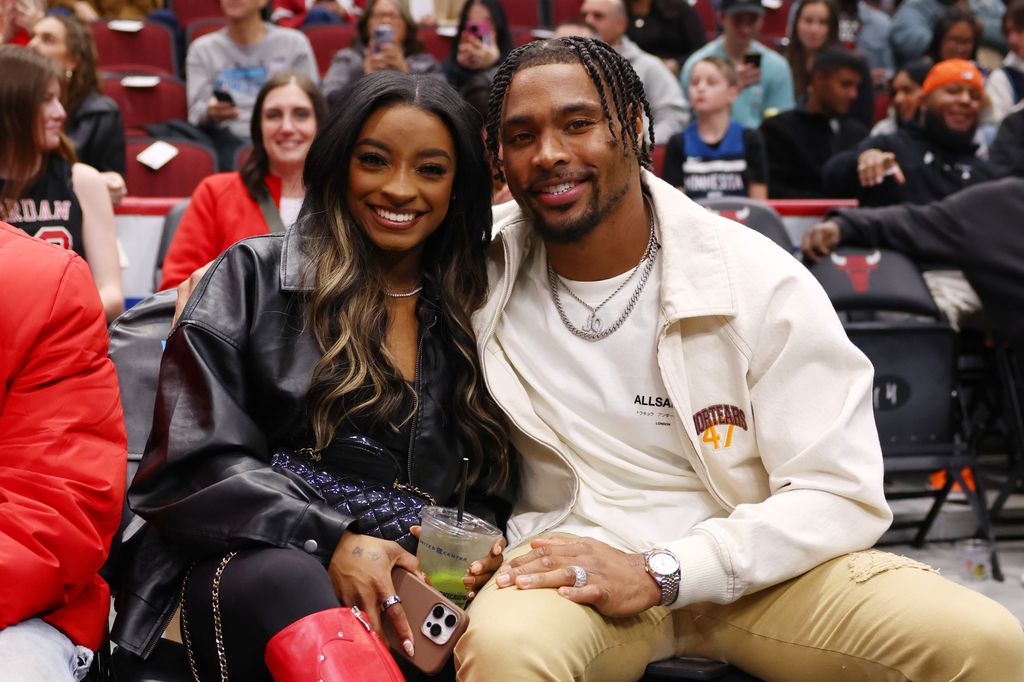 Simone Biles and Jonathan Owens pose for a photo during the first half between the Chicago Bulls and the Minnesota Timberwolves at the United Center on November 07, 2024 in Chicago, Illinois.