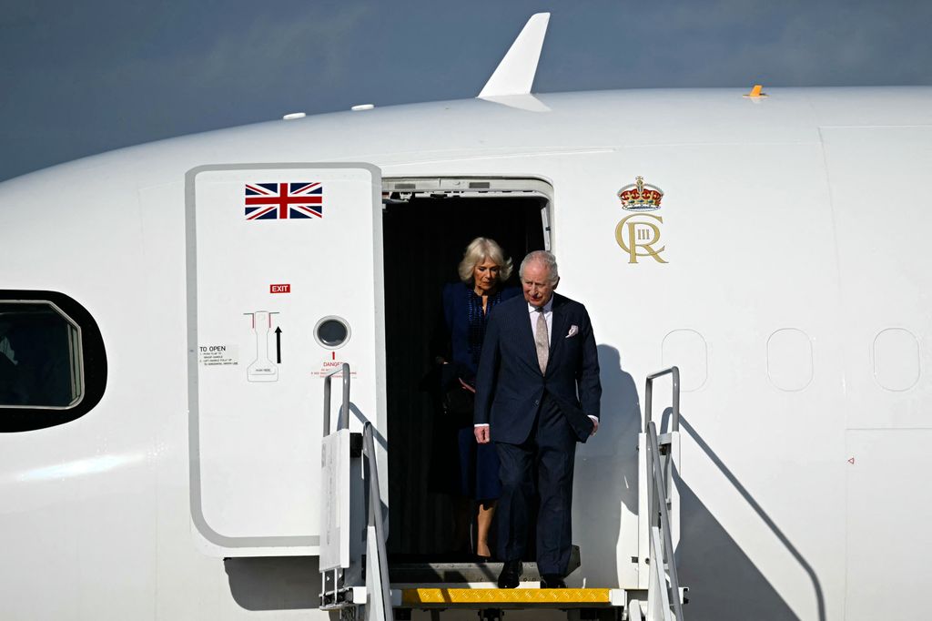 charles and camilla exiting plane