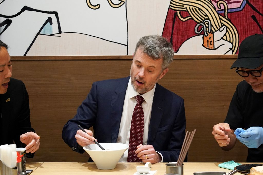 King Frederik using chopsticks at ramen restaurant in Japan