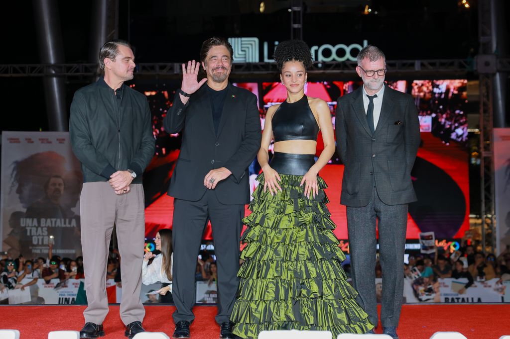 Leonardo DiCaprio, Benicio del Toro, Chase Infiniti, and Paul Thomas Anderson pose during the fan event for the movie 'One Battle After Another' in 2025