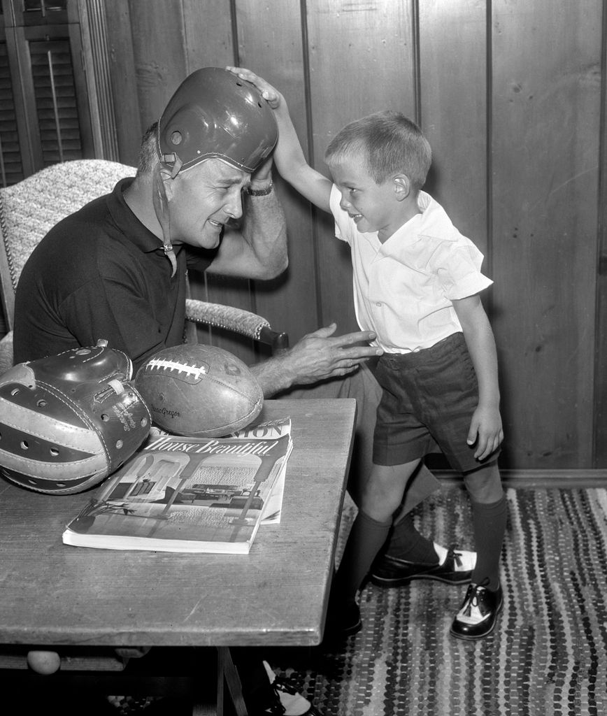 Tom Harmon, retired professional football player, a KNX / CBS sportscaster relaxes at home and with his son, Mark Harmon (who later becomes a notable actor). September 4, 1956. Los Angeles, CA