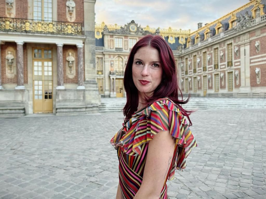 Maggie McGraw poses for a photo in Versailles showing off her red hair, shared on Instagram