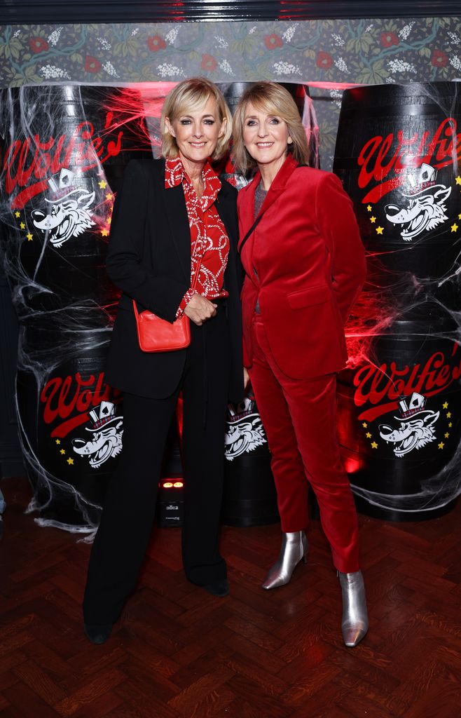 Jane Moore and Kaye Adams in red at party