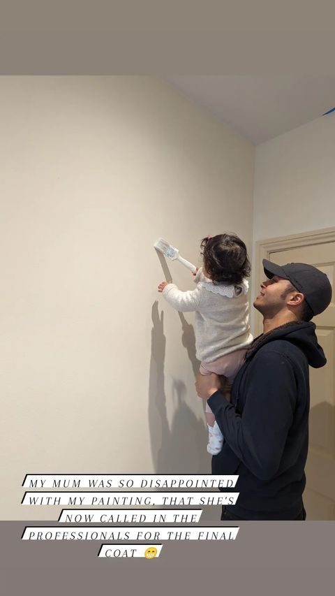 Will Kirk painting walls with his daughter