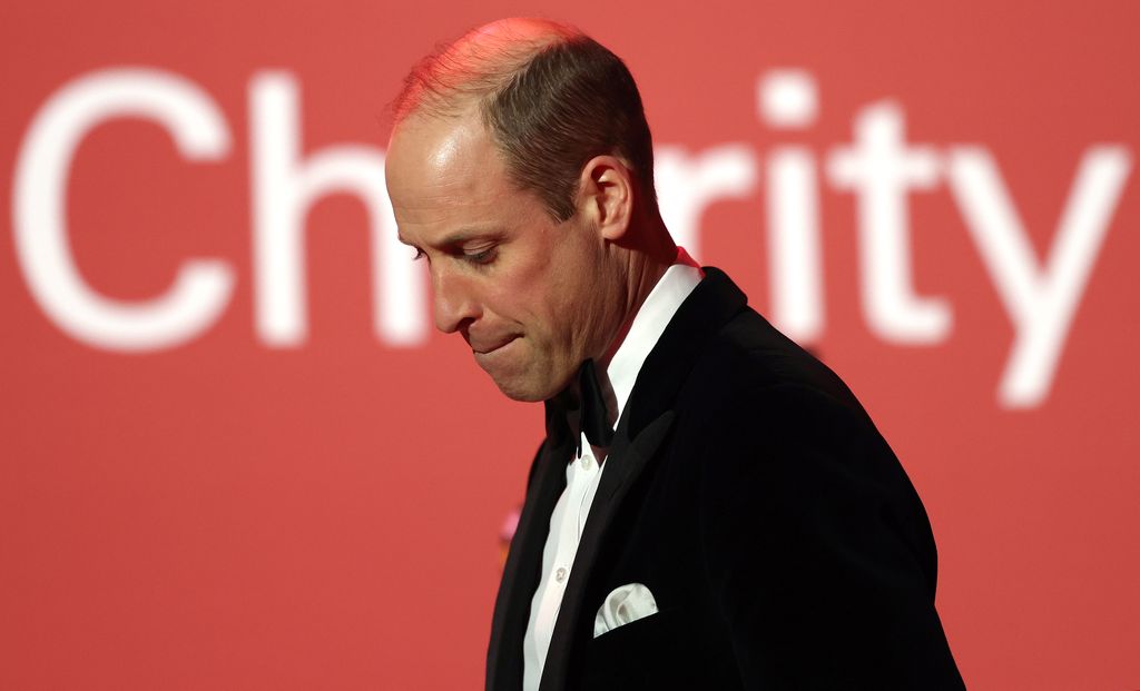 Prince William looking down as he leaves stage