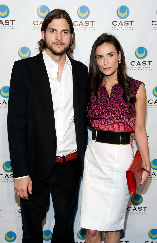 Ashton Kutcher standing with Demi Moore