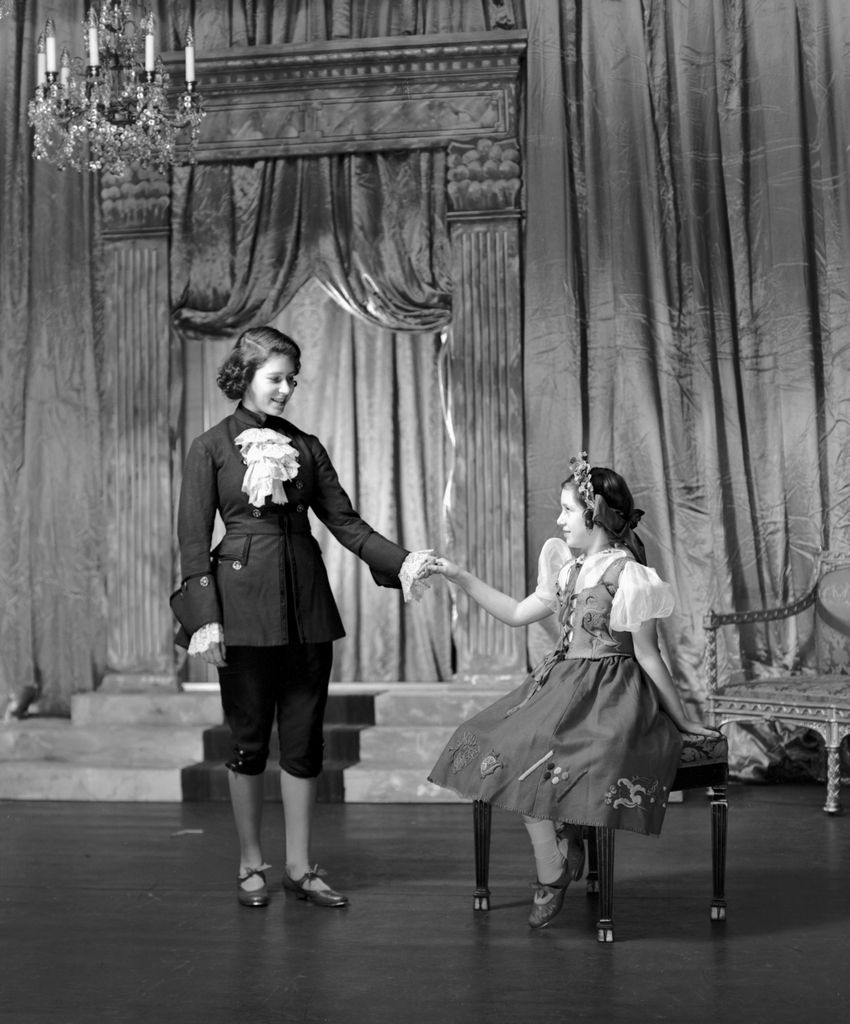 Queen Elizabeth playing Prince Charming alongside her sister Princess Margaret in their school pantomime in 1941