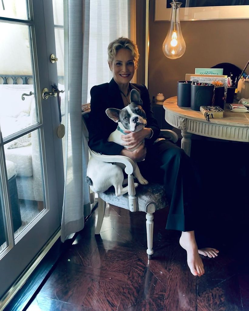 Sharon Stone with her dog in her home