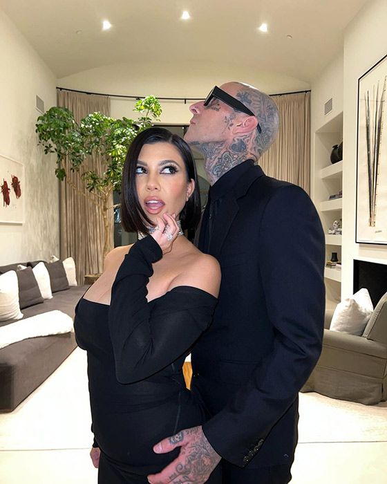 Kourtney Kardashian and Travis Baker posing together in all black looks