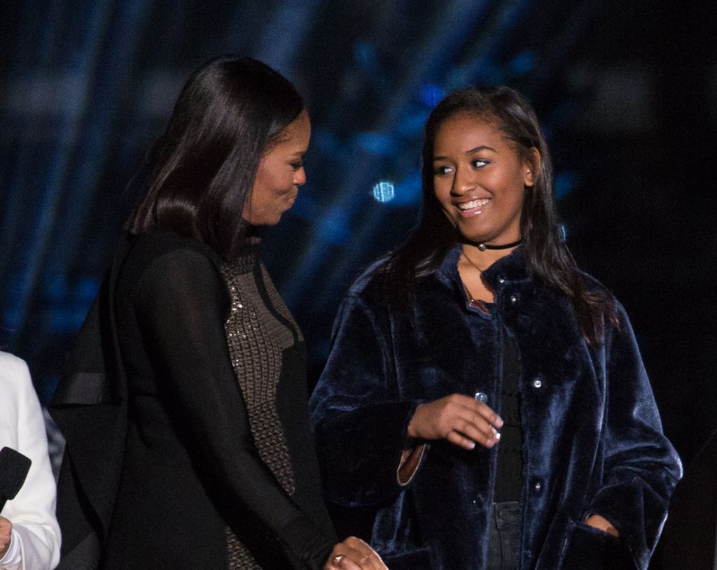 Michelle Obama looking at daughter Sasha smiling