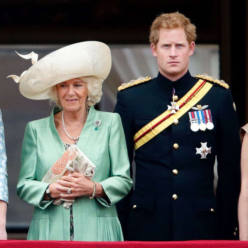 Queen Camilla in a green coat and Prince Harry in his black military uniform