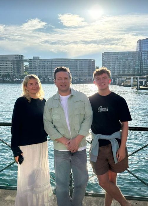 Jamie Oliver standing with his daughter and her boyfriend