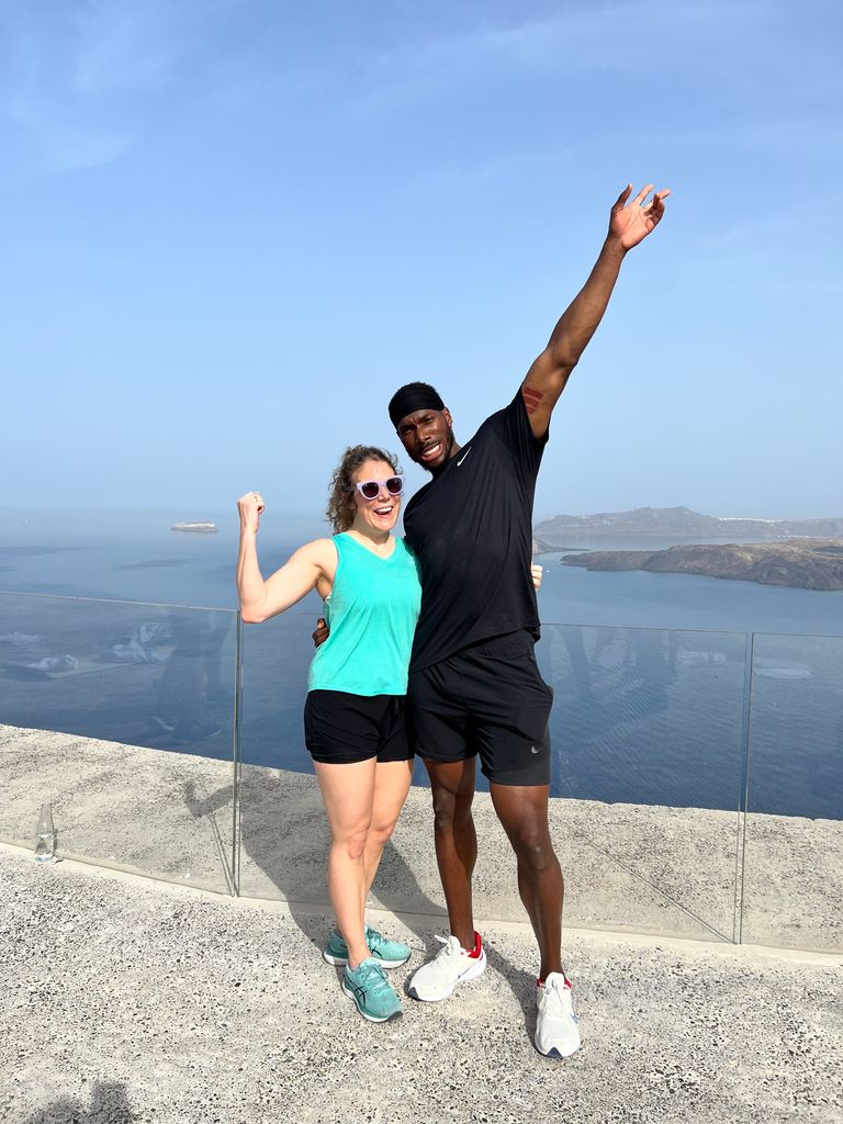 two people posing in front of the sea