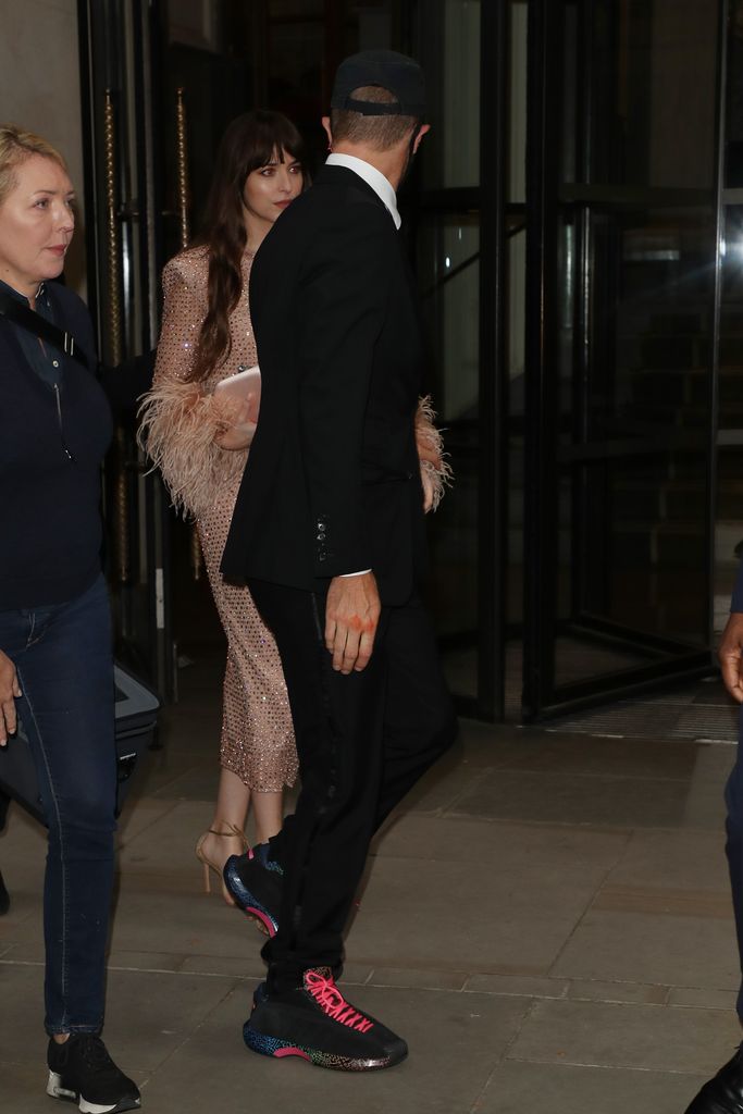 Chris Martin and Dakota Johnson seen leaving The Corinthia Hotel ahead of the "The Lost Daughter" UK Premiere during the 65th BFI London Film Festival at The Royal Festival Hall on October 13, 2021 in London, England
