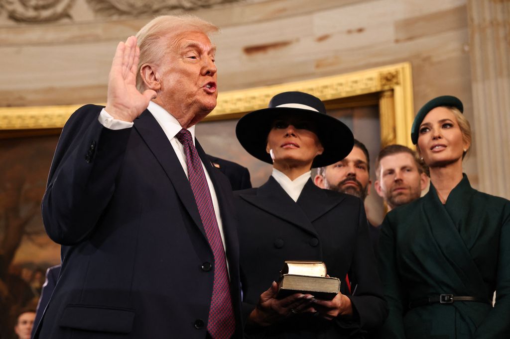 President-elect Donald Trump takes the oath of office as Melania Trump, Ivanka Trump, Donald Trump Jr. and Eric Trump look on during inauguration ceremonies in the Rotunda of the U.S. Capitol o