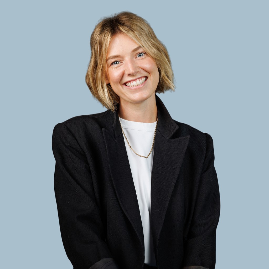 blonde woman smiling with black blazer on 