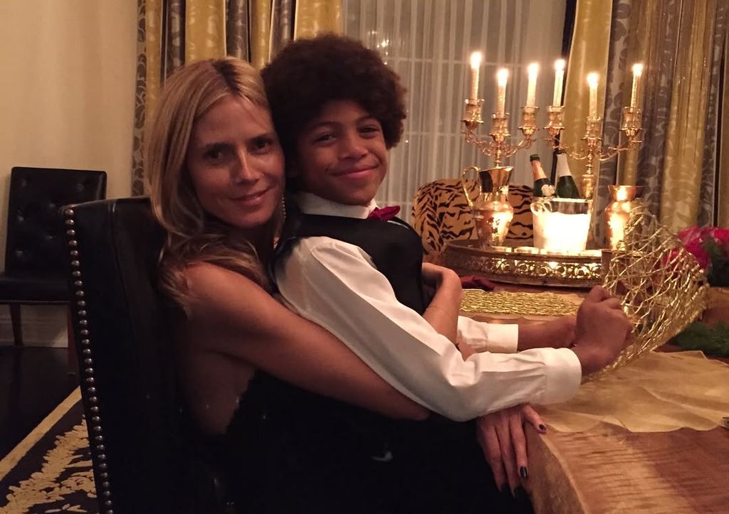 Henry Samuel in shirt and waistcoat sat on his mom Heidi Klum's lap at dinner