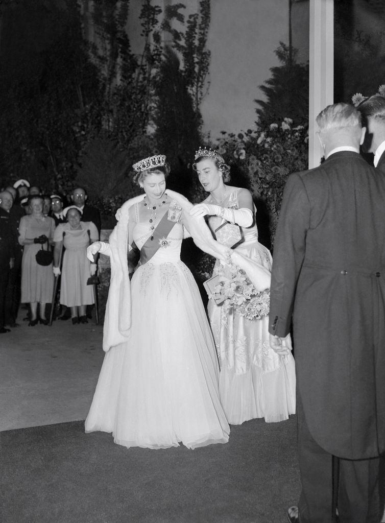 Lady Pamela adjusts Queen Elizabeth's stole at the Royal Ball in Melbourne, March 1954