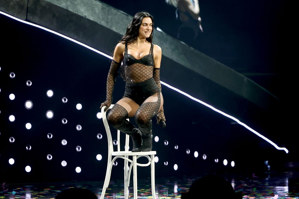 Dua Lipa's in Gucci tour look on stage