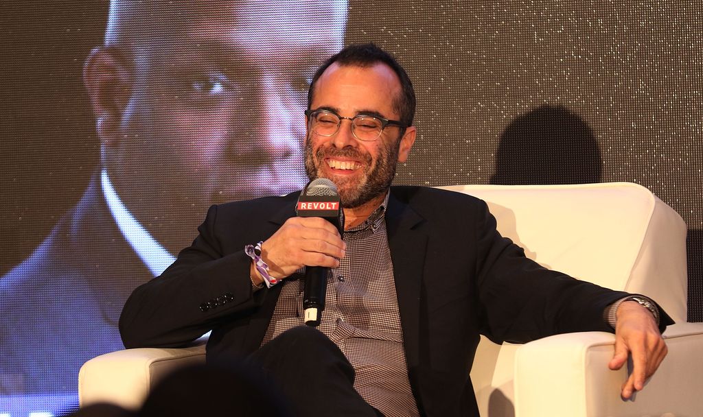 Steven Greener smiling into a microphone