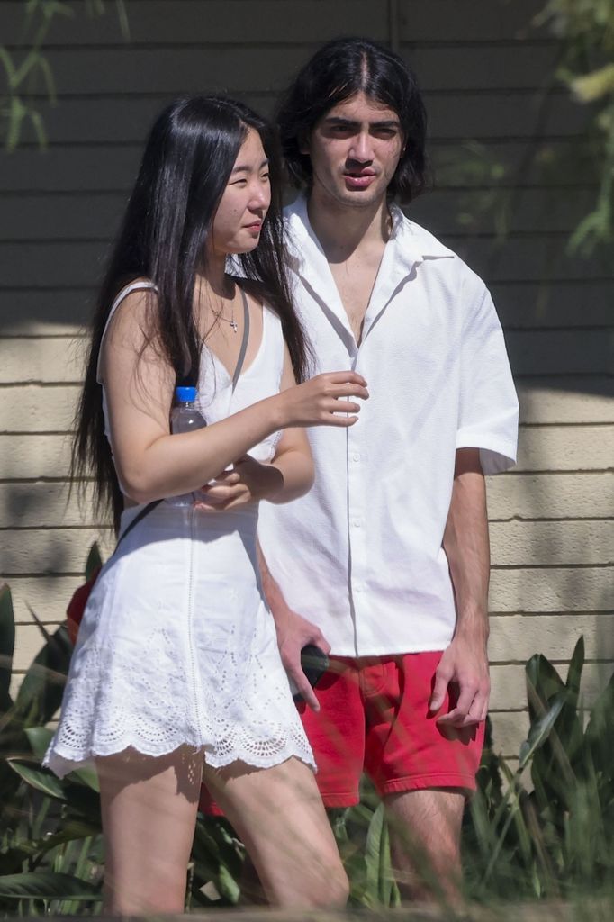 Bigi with female friend in matching white outfits