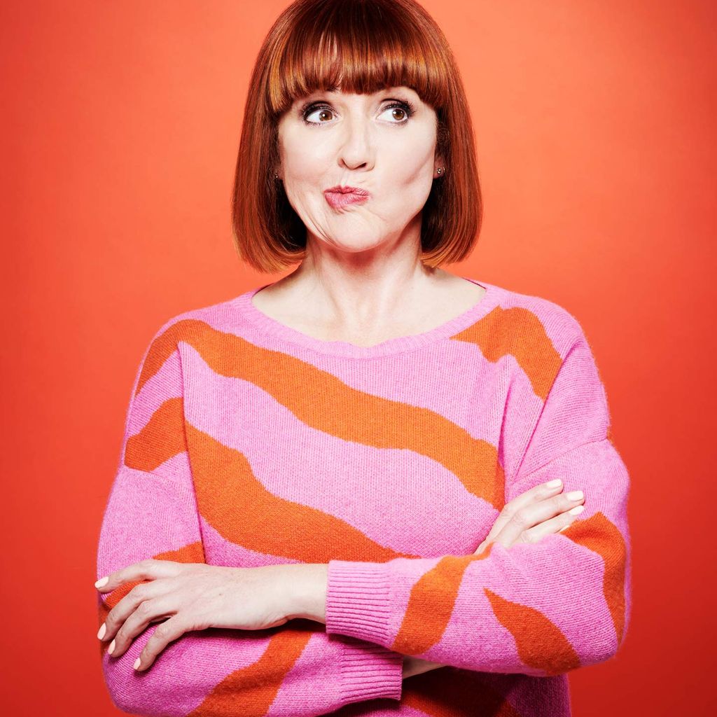Woman in pink and orange striped jumper pulling a face for the camera