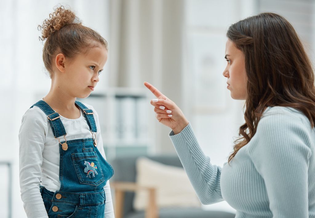 mother pointing finger at strong willed child