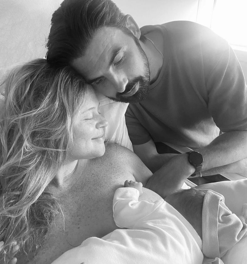 Emily Atack breastfeeding with her boyfriend next to her