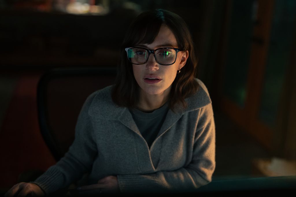 woman looking at computer in dark room