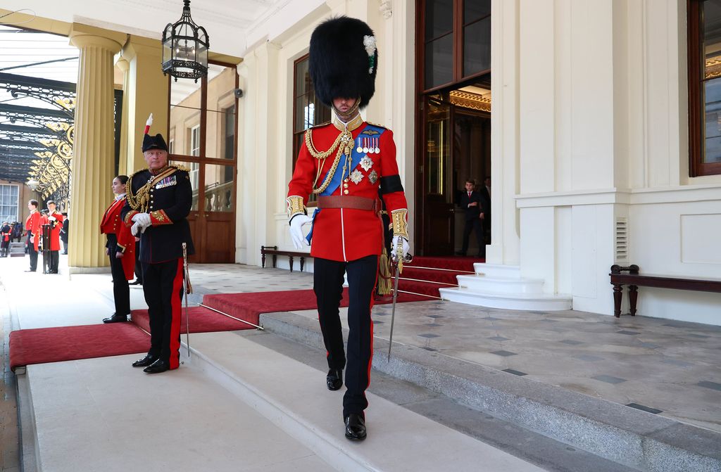 Prince Louis looks on at Prince William