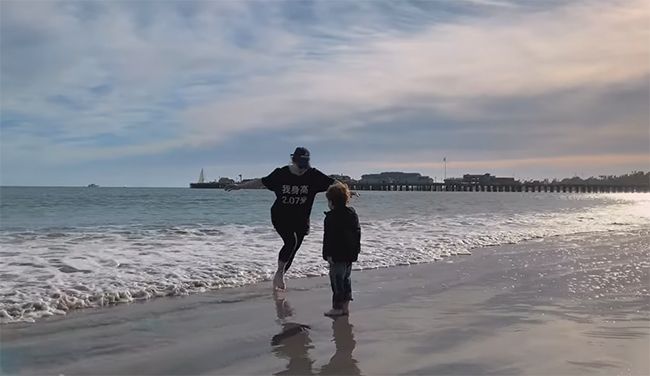 Eugenie and Archie run on the beach in California