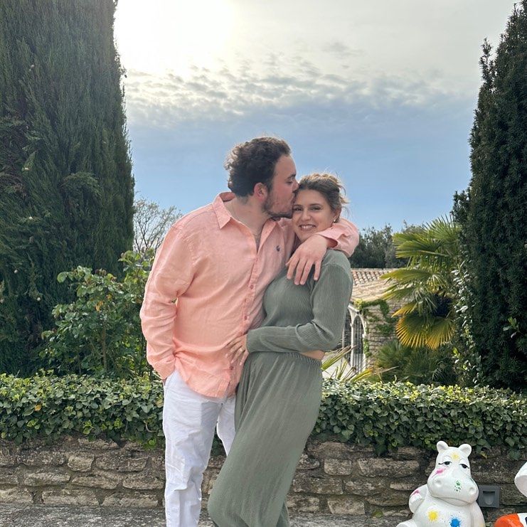 Johanna Thiébaud and her boyfriend pose for a photo beside a green valley, shared on Instagram