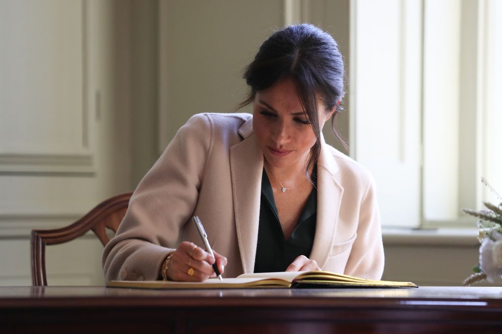 Meghan Markle writing in a book