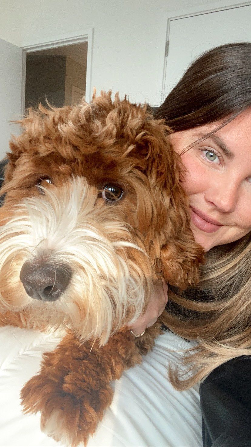 Woman cuddling a cockapoo