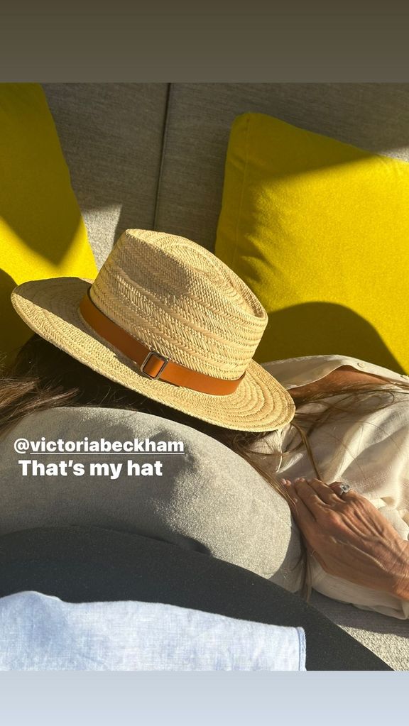 Victoria Beckham napping with a hat over her face 