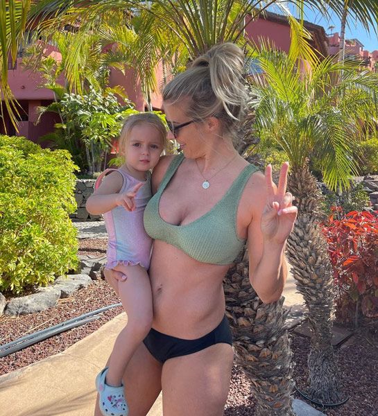 gemma atkinson wearing green bikini holding daughter mia