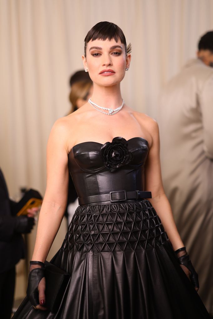 Lily James honours Karl Lagerfeld's signature accessory and has