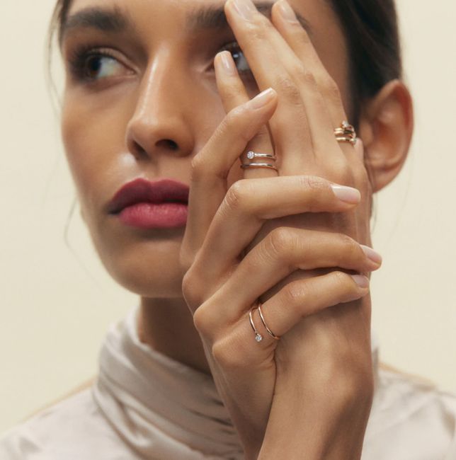 a model wearing multiple rings