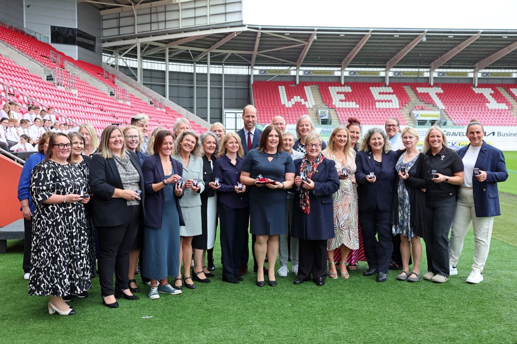 Prince William poses with former players who have received WRU's Missing Caps campaign brooches during a visit to Parc y Scarlets