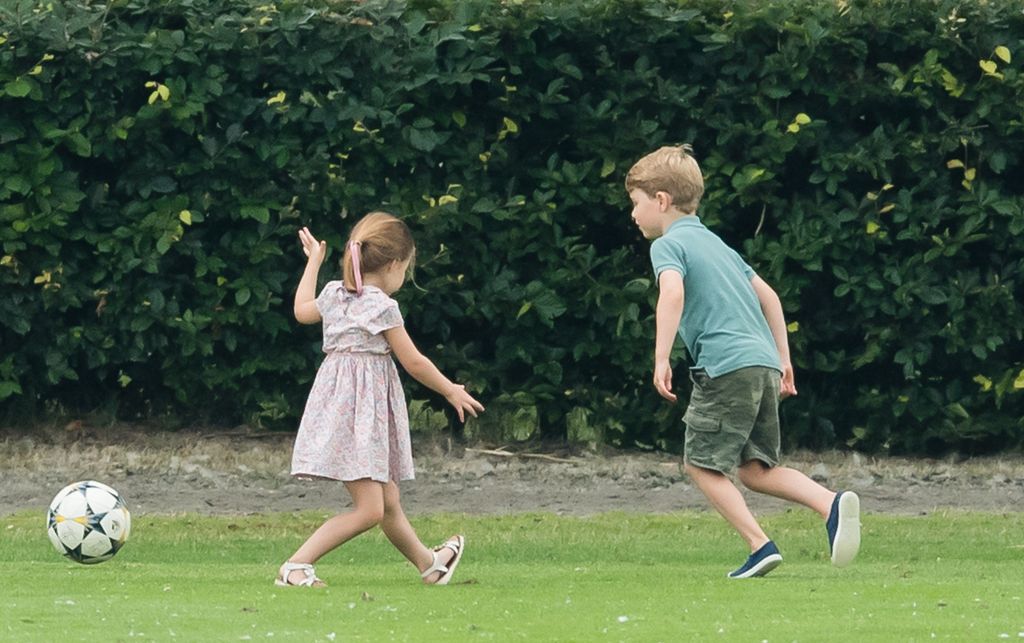 George and Charlotte enjoy a kickabout