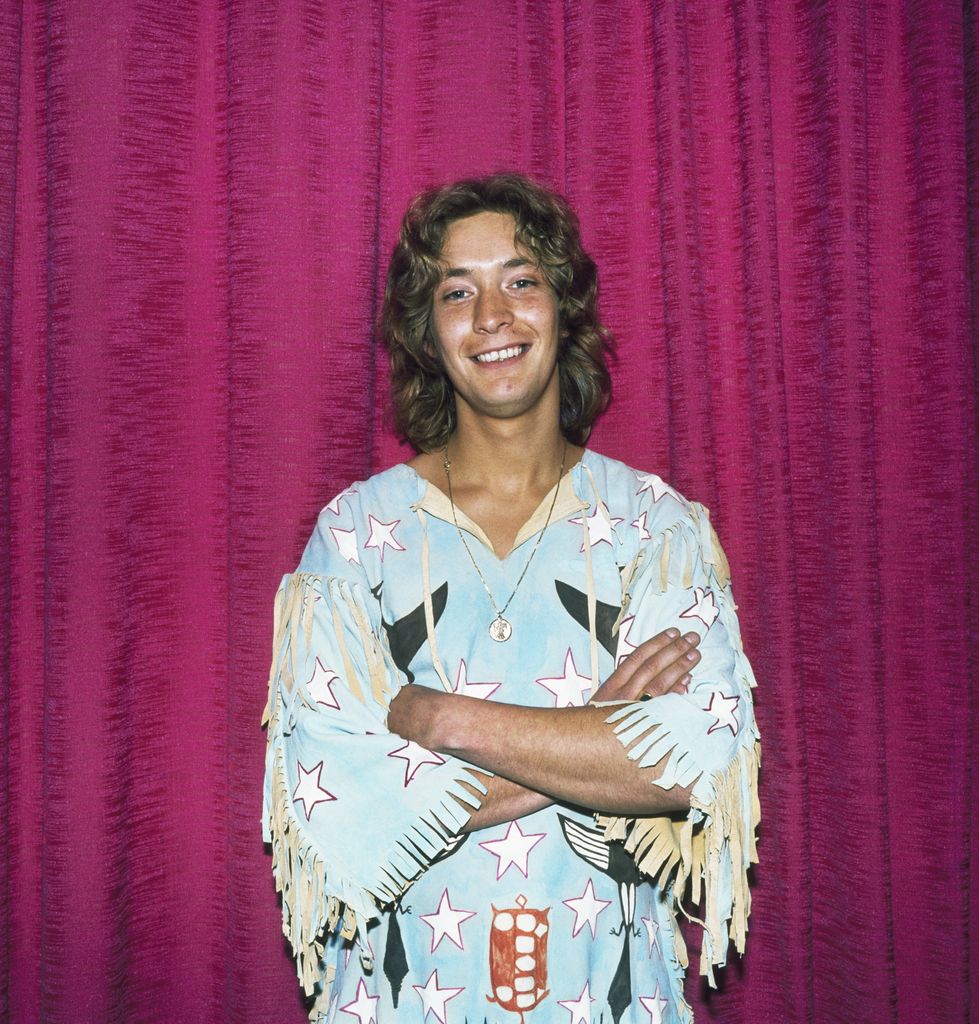 Portrait of English musician Chris Rea as he poses with his arms folded