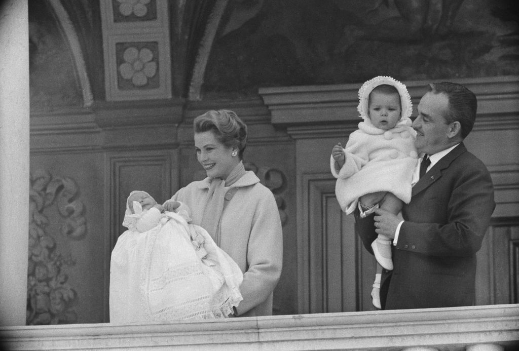 Grace Kelly holiding baby Prince Albert and Prince Rainier holding baby Princess Caroline
