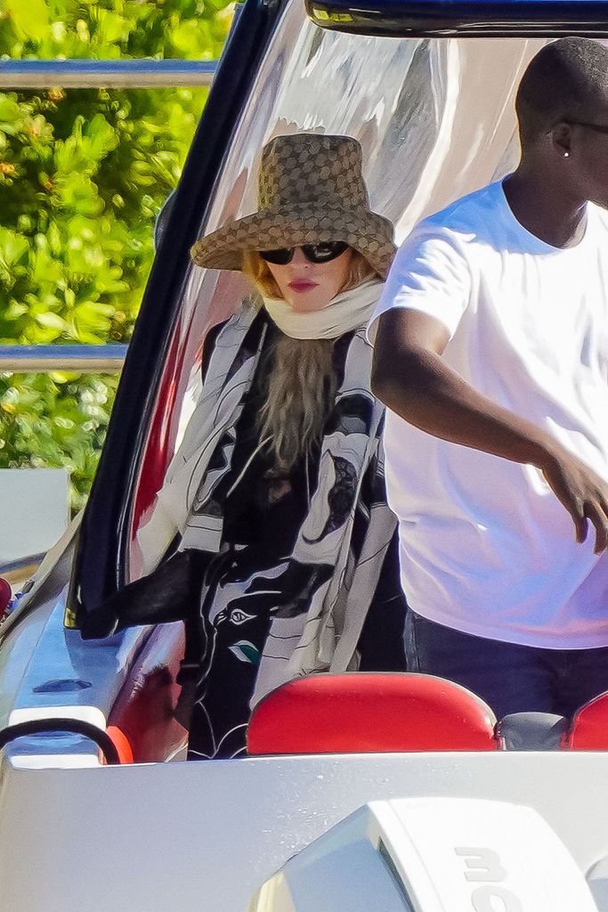 Madonna, 65, stayed wrapped from head to toe to protect herself from the sun