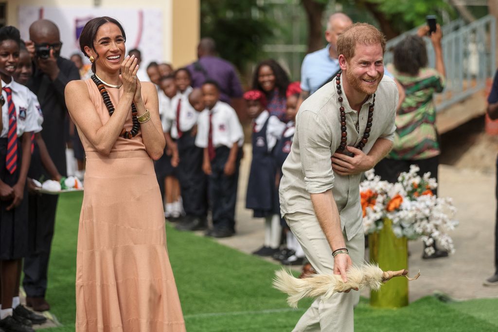 Meghan laughs as Harry takes part in activities