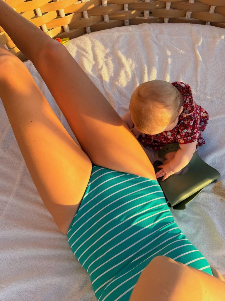 Carrie Johnson wearing a turquoise swimsuit